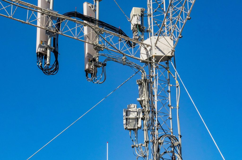 Close-up of a telecommunication tower against a clear blue sky, highlighting modern infrastructure.